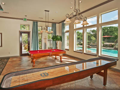 Lavish resident clubhouse with billiards and shuffleboard at The Landing at Mansfield in Mansfield, Texas
