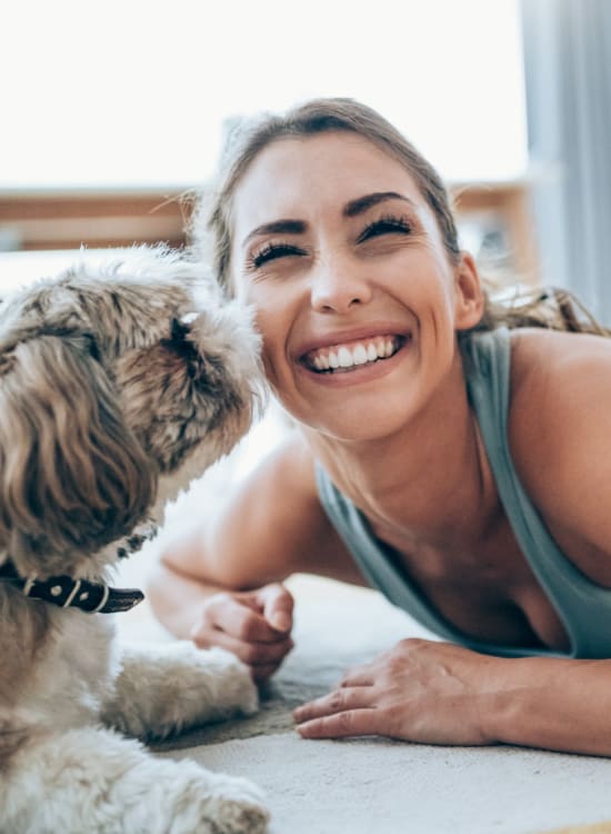 Resident relaxing with her small dog at Solaire 1150 Ripley in Silver Spring, Maryland