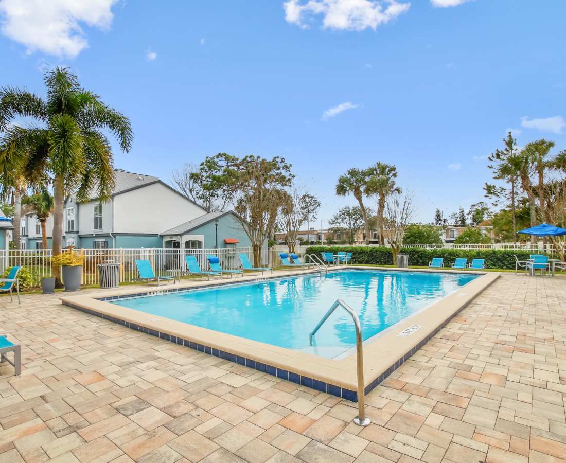 Seating area alongside the pool at The Canopy Apartment Villas in Orlando, Florida
