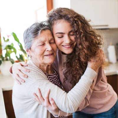 Resident hugging a younger family member at Wildwood Manor Apartments