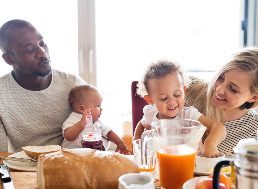 A family eating a meal in a home at Breezy Point in Norfolk, Virginia