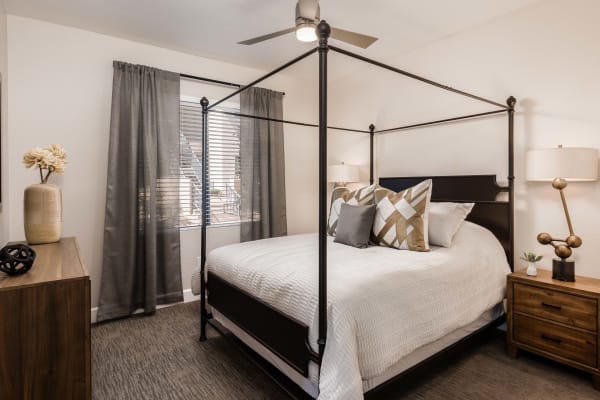Beautiful master bedroom with a ceiling fan to stay cool in a model home at Elite North Scottsdale in Scottsdale, Arizona