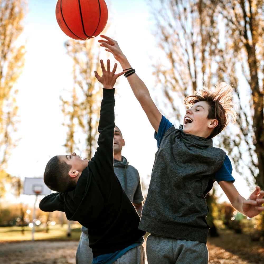 Residents playing with a ball in the playground near Los Flamboyanes in Rochester, New York