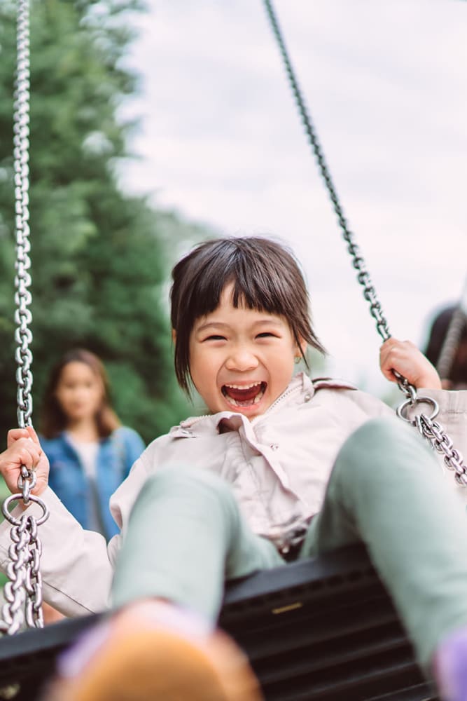 A child swinging at a park near Vista Villa in Charlotte, North Carolina