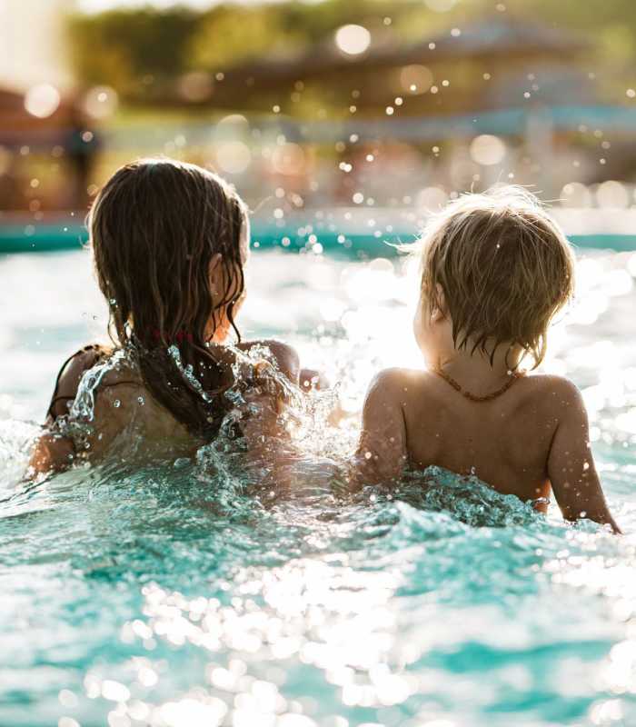 Children playing in a sparkling pool, splashing water around at Standard at Royal Lane in Dallas, Texas