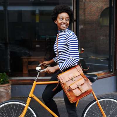A woman riding a bicycle on the street at Edge DTC in Denver, Colorado