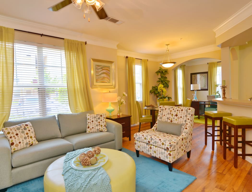 Interior model home living room with hardwood floors and ceiling fan at IMT Kingwood in Kingwood, Texas