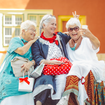 Smiling residents taking a selfie at Meadow Creek Senior Living in Lancaster, Texas