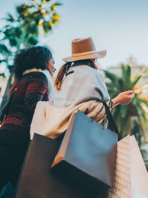 Two women carrying shopping bags near Palmhouse Jacksonville in Jacksonville, Florida