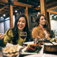 Resident friends out for a feast at their favorite restaurant near Box Board Lofts in Grand Rapids, Michigan