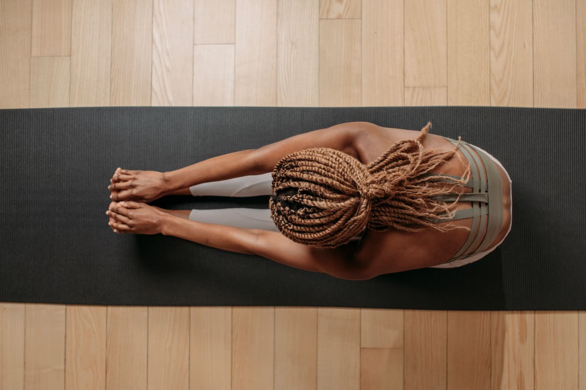 Woman stretching on a yoga mat at Claremont Towers in Hillsborough, New Jersey