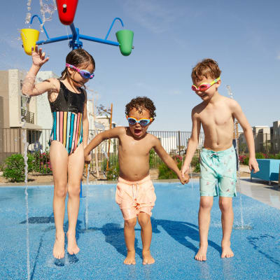 Kids playing in the splash park on a hot sunny day at BB Living in Scottsdale, Arizona