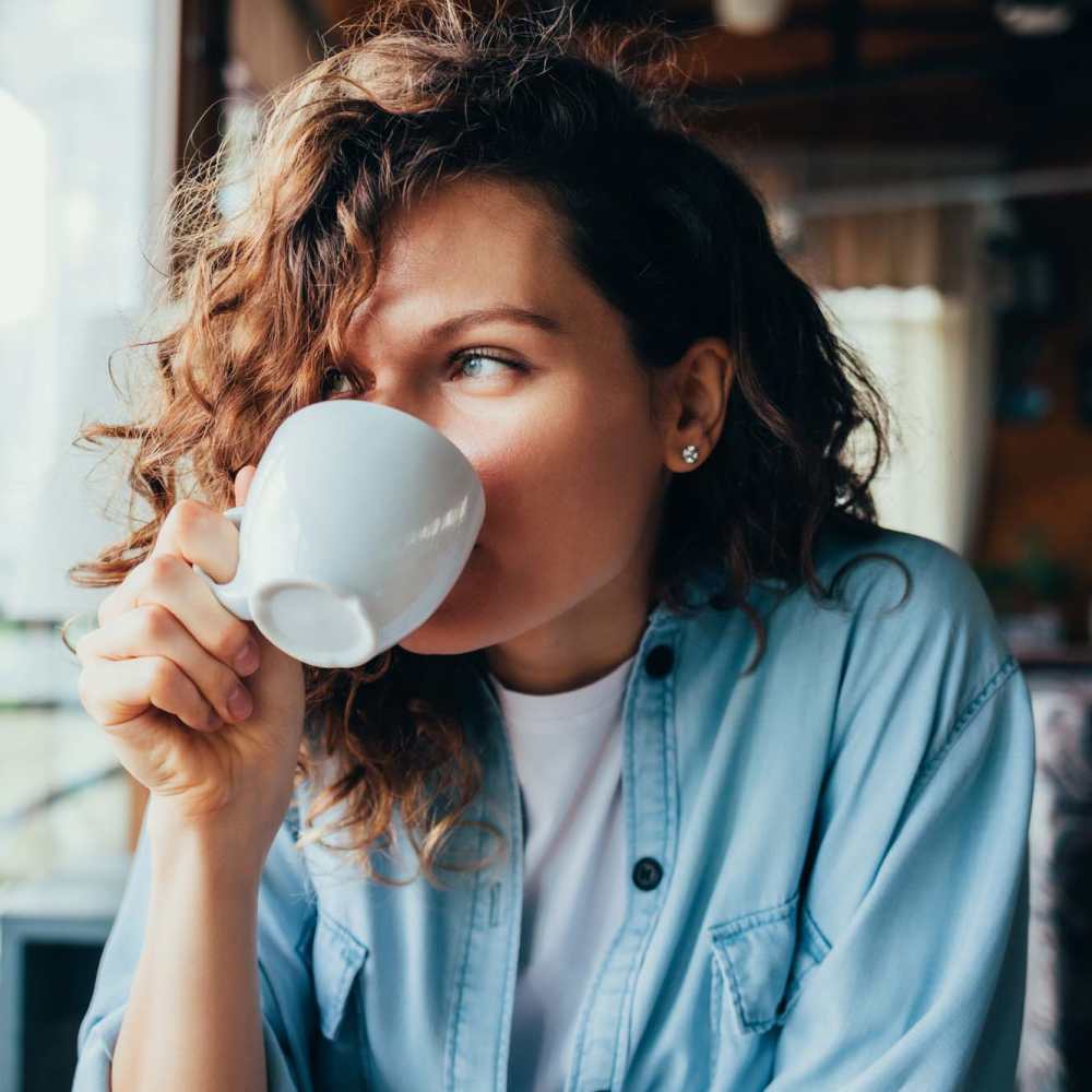 Resident woman having coffee at a cafe near Middlebrook Trace II in Staunton, Virginia