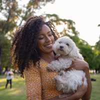 Resident with her dog in the park near Roosevelt Park Apartments in San Jose, California