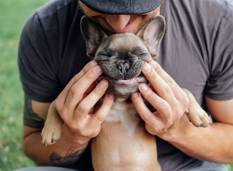 Resident posing with his pup outside their new home at Waterstone Fremont in Fremont, California