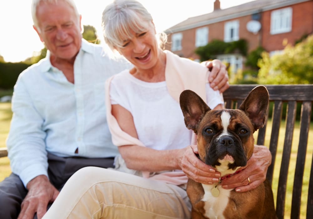 Residents sitting with dog near Holden of Bellevue in Bellevue, Washington. 