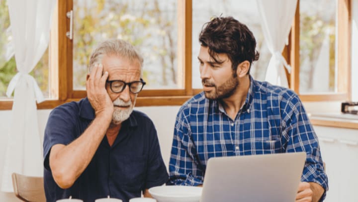 older man looking a laptop 
