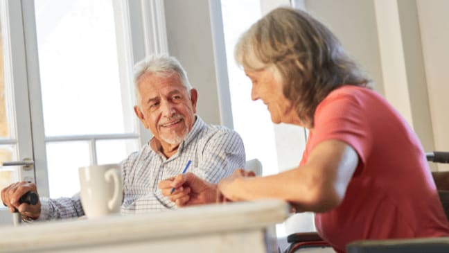 a senior couple smiling eachother