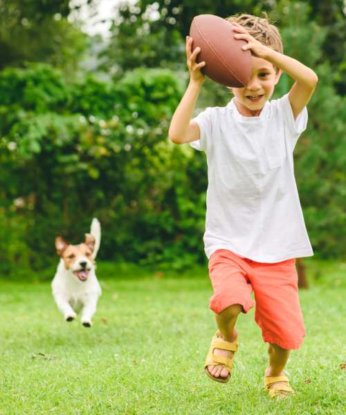 Resident child playing with his dog at Westwood Apartments in Davis, California