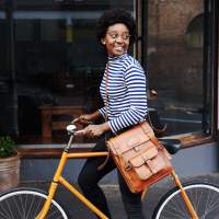 Resident using her bicycle on a street near Woodchase Apartments in San Leandro, California