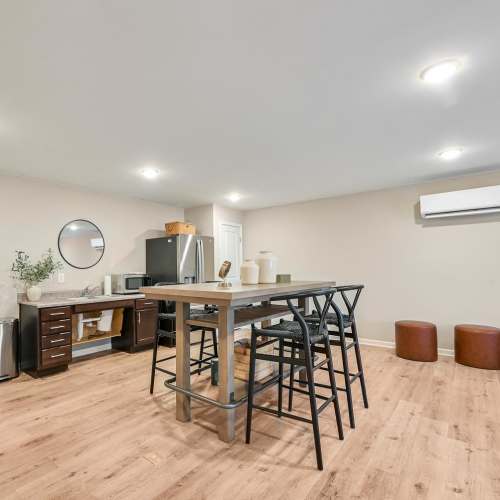 Community kitchen with bar counter and chairs at Hawkins Pointe in Hendersonville, North Carolina