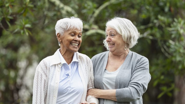 Two elderly women smiling.