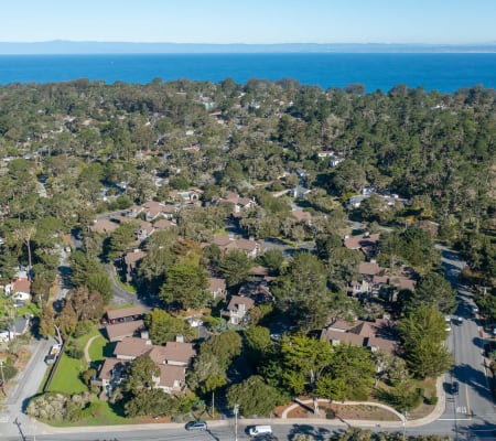 Aerial view of Seventeen Mile Drive Village Apartment Homes in Pacific Grove, California near the ocean