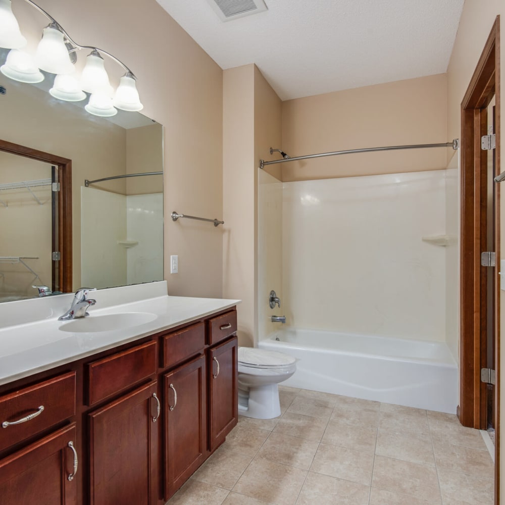 Large vanity mirror in a model apartment's bathroom at Oaks Glen Lake in Minnetonka, Minnesota