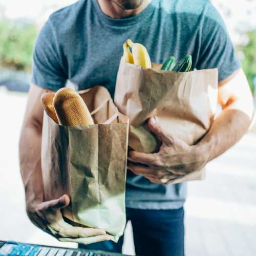 Resident placing grocery bags in the car near Bellflower Friendship Manor in Bellflower, California