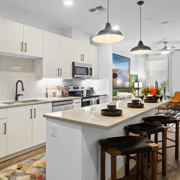 Luxury kitchen and living room at District at Civic Square in Goodyear, Arizona