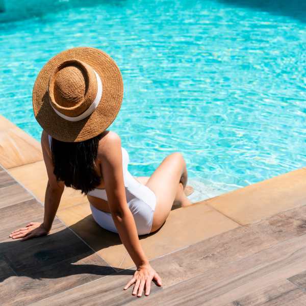 Woman relaxing at poolside at The Abbey at Spring Town Center