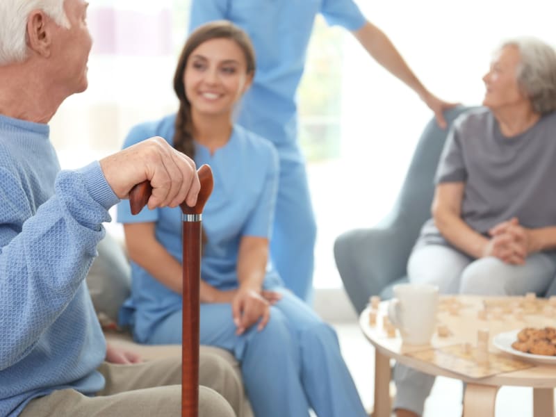 Caregiver sitting with residents at Holton Manor in Elkhorn, Wisconsin