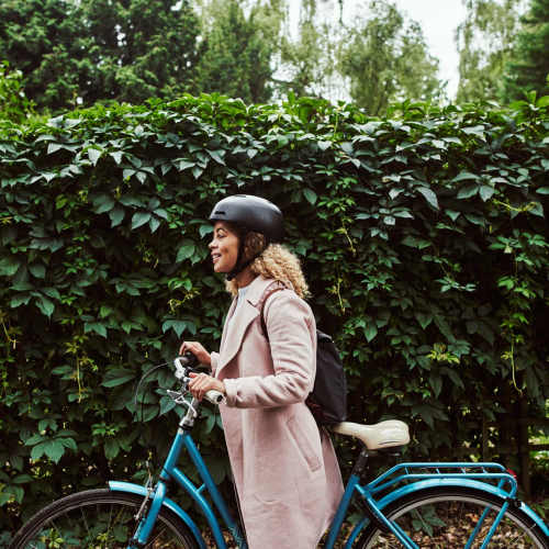 Woman biking to work near Villas At Camino Bernardo in San Diego, California