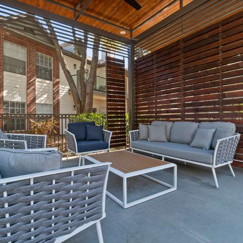 Outdoor lounge area with couch,chairs and ceiling fan at Charleston in San Antonio,Texas