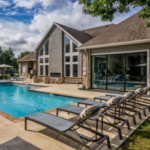 Lounge chairs by the pool at Park Creek Apartments in Fort Worth, Texas
