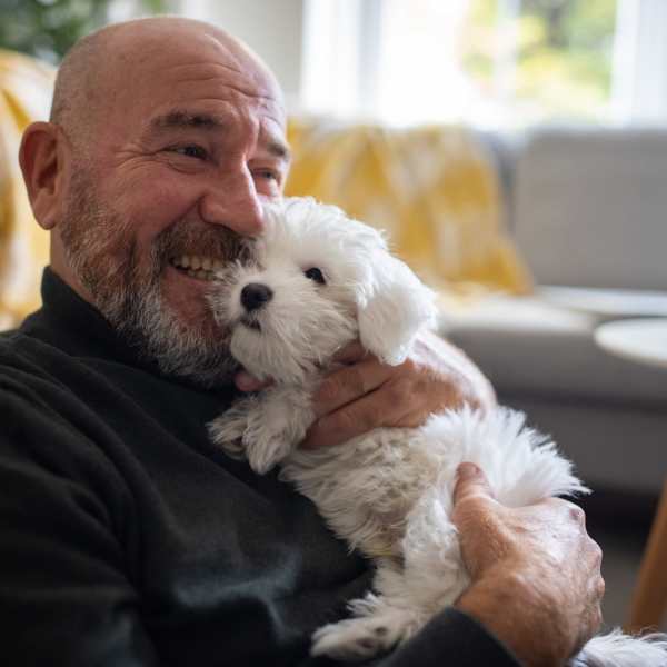 A resident holds his puppy at Attain at Towne Place, Chesapeake, Virginia