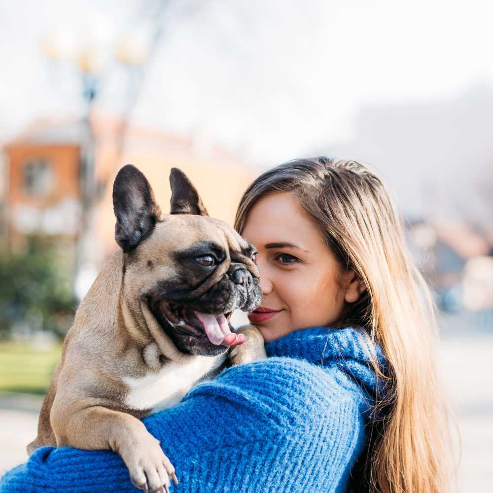 Resident holding their dog at The Elysian at Stonefield in Charlottesville, Virginia