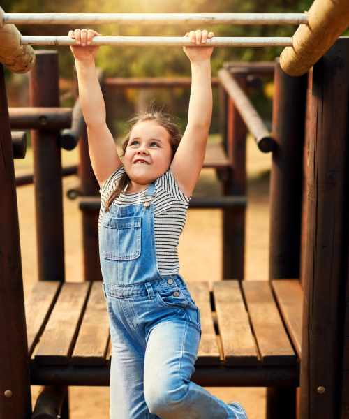 Kid happily playing in the neighborhood at Ironwood Greens in Gresham, Oregon