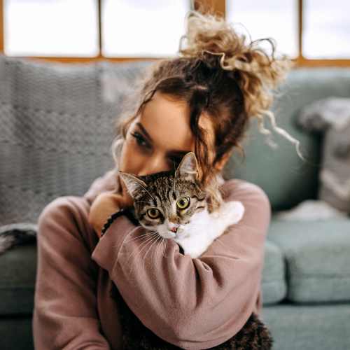 Resident hugging her cat at Ventura Park Plaza Apartments in Portland, Oregon