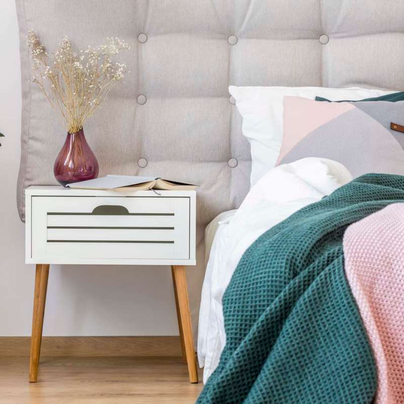 Bedroom with side table at Waterstone Place Apartments in Stafford, Texas