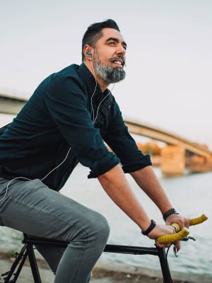 A man biking to work from his apartment at Ambrose in Bremerton, Washington