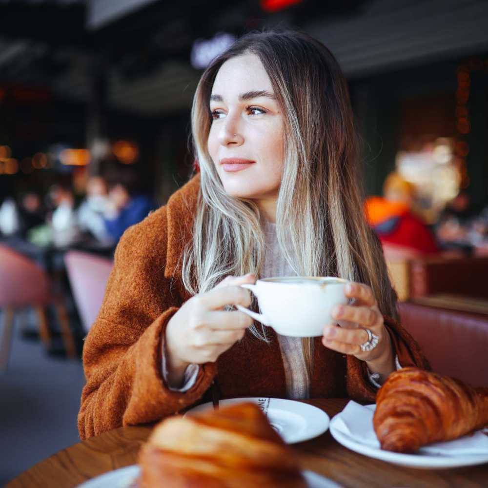 Resident having coffee at restaurant near Osprey Place Apartments in North Charleston, South Carolina