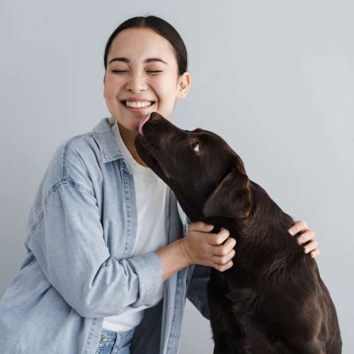 Happy woman holding her dog at The Gramercy Residences in Las Vegas,