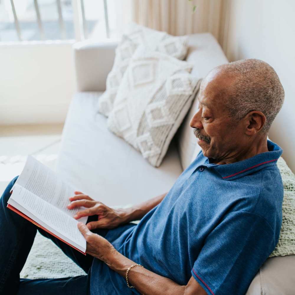Resident reading in an apartment at Grande Oak Apartments in Williamsburg, Virginia