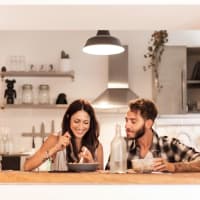 Resident couple enjoying dinner in their unit at Bayside Villas in Panama City, Florida