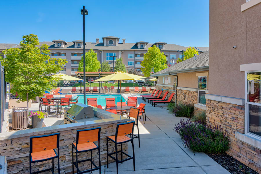 Ample outdoor seating near the clubhouse and pool areas at Meadowbrook Station Apartments in Salt Lake City, Utah