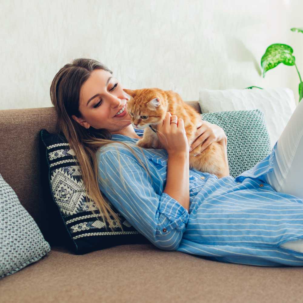 Resident relaxing with her cat in their new pet-friendly home at The Ridge in Merrillville, Indiana