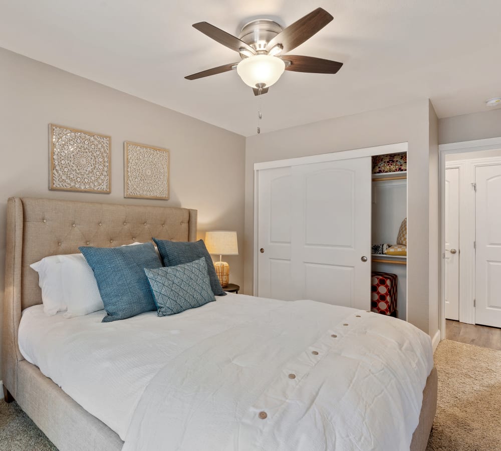 Model bedroom with plush carpeting at Pinebrook Apartment Homes in Fremont, California