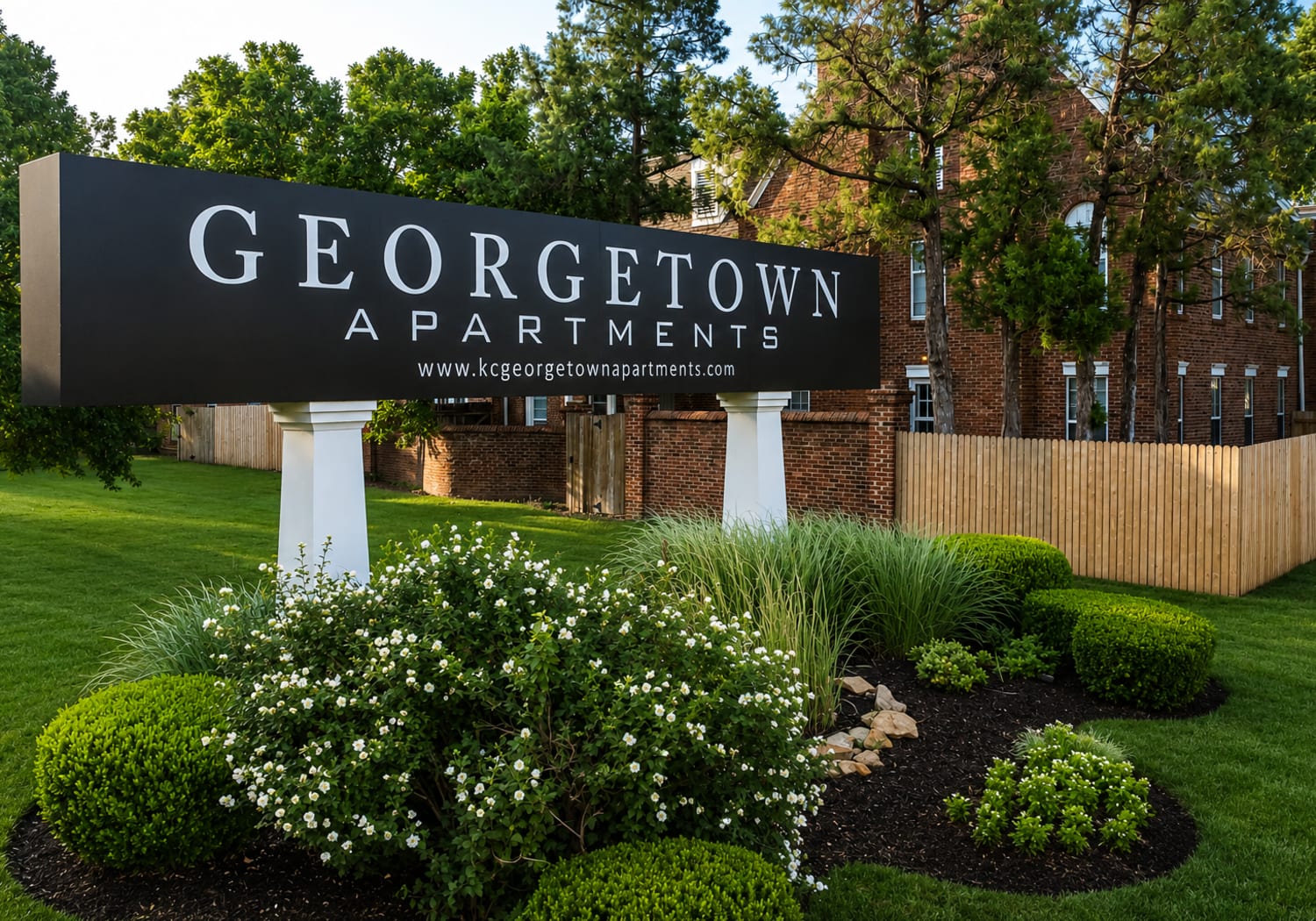 Community signage board with building at Georgetown Apartments in Merriam, Kansas