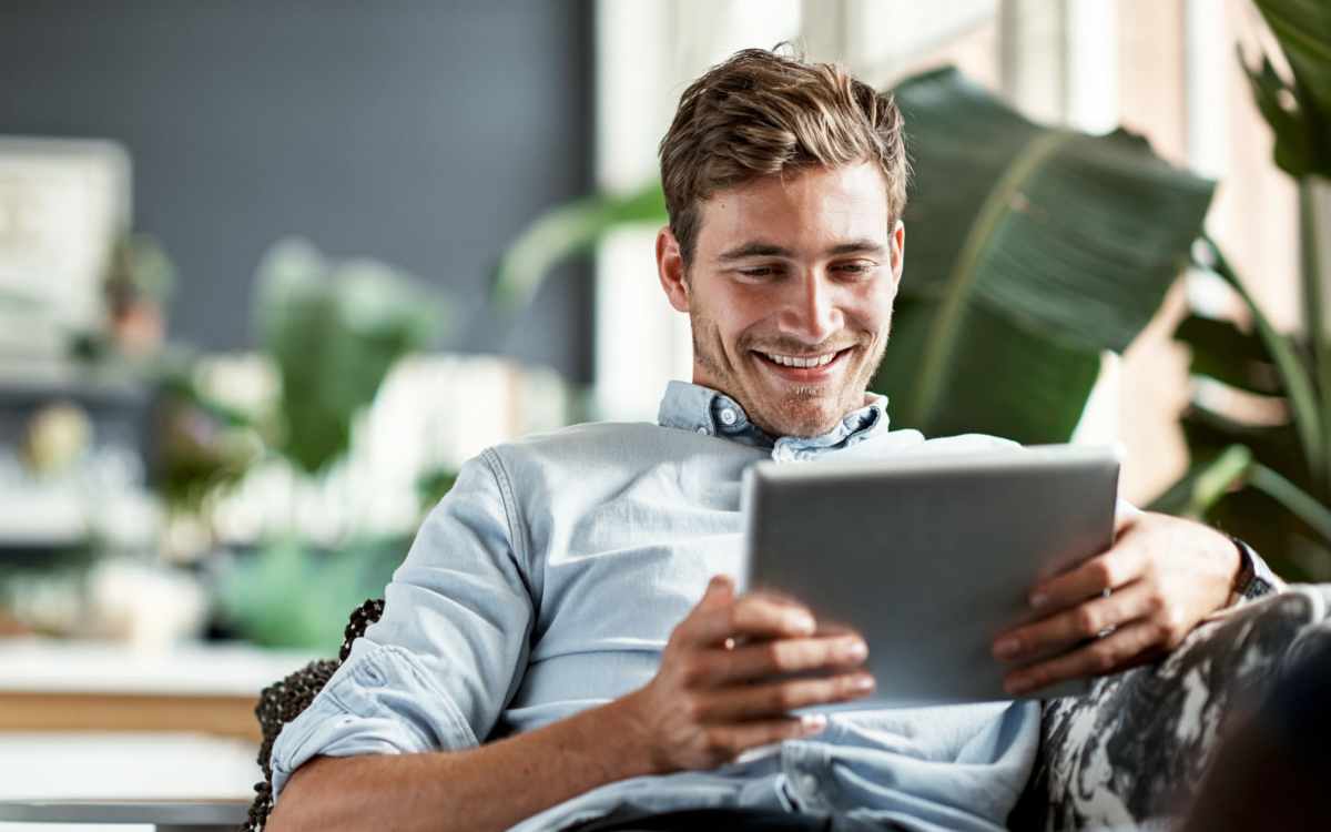 Resident using tab in home at Renton Sage in Renton, Washington